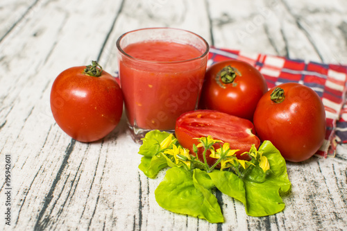 Tomato smoothie - tomato juice on wood background