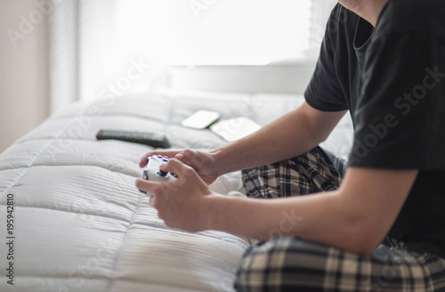 Soft focus guy playing video games in morning light