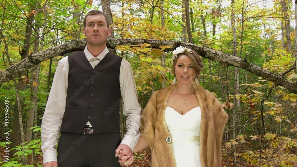 bride and groom hold hands in the woods slow motion 4k Stock Video ...