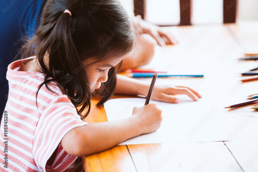 Asian child girl drawing and painting with her friend with fun together Asian child girl drawing and painting with her friend with fun together
