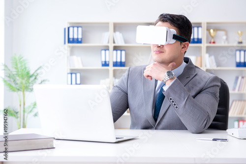 Businessman with virtual reality glasses in modern technology co