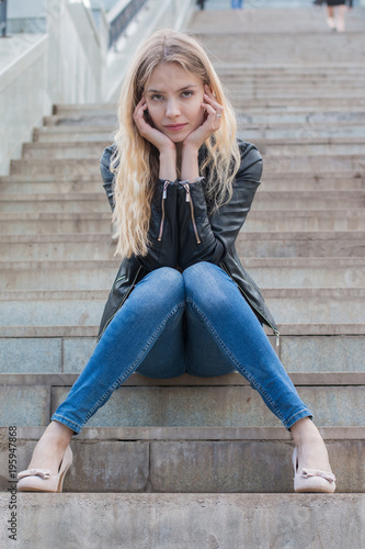 Girl with blond hair on the stairs