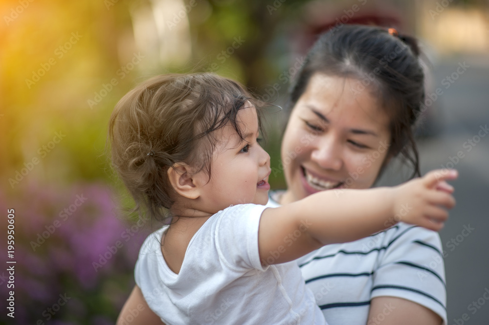 Sweet Beautiful baby girl with hug of mother and playing. Happy loving family kissing and hugging. Sweet Beautiful baby girl with hug of mother and playing. Happy loving family kissing and hugging.