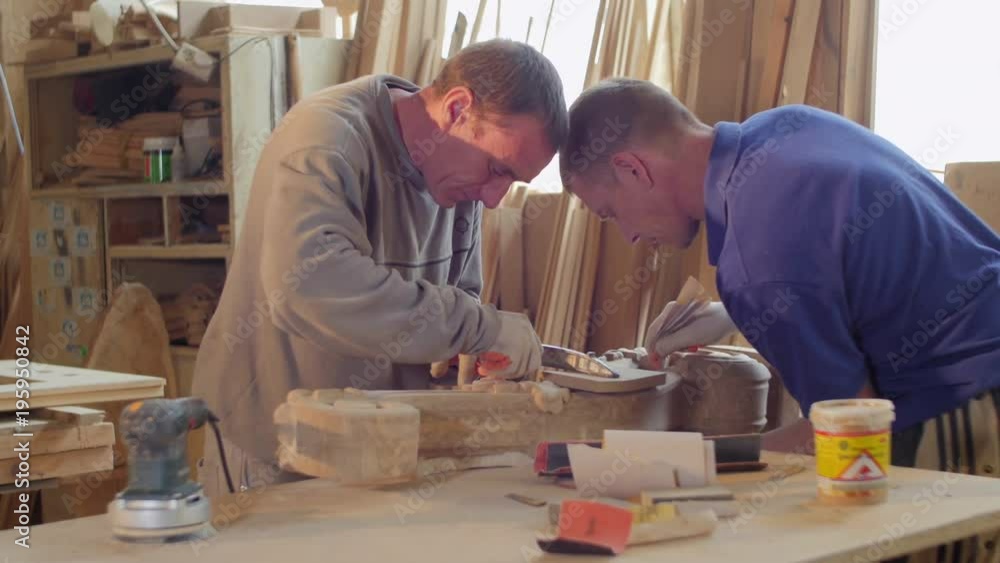 Carpenters sanding Carpenters sanding