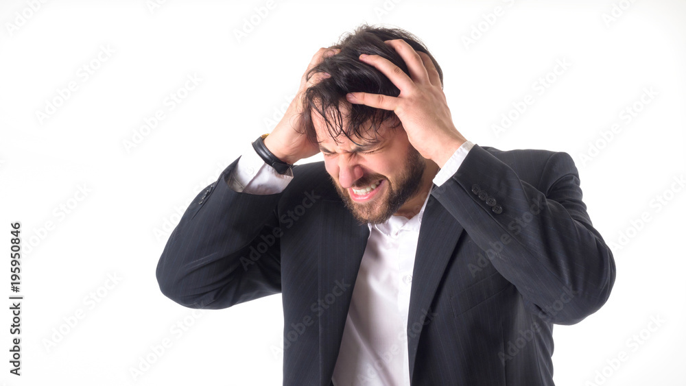 the businessman has a strong headache. He holds his hands on his head and closed his eyes in pain. Close-up portrait. Isolated on white. the businessman has a strong headache. He holds his hands on his head and closed his eyes in pain. Close-up portrait. Isolated on white.