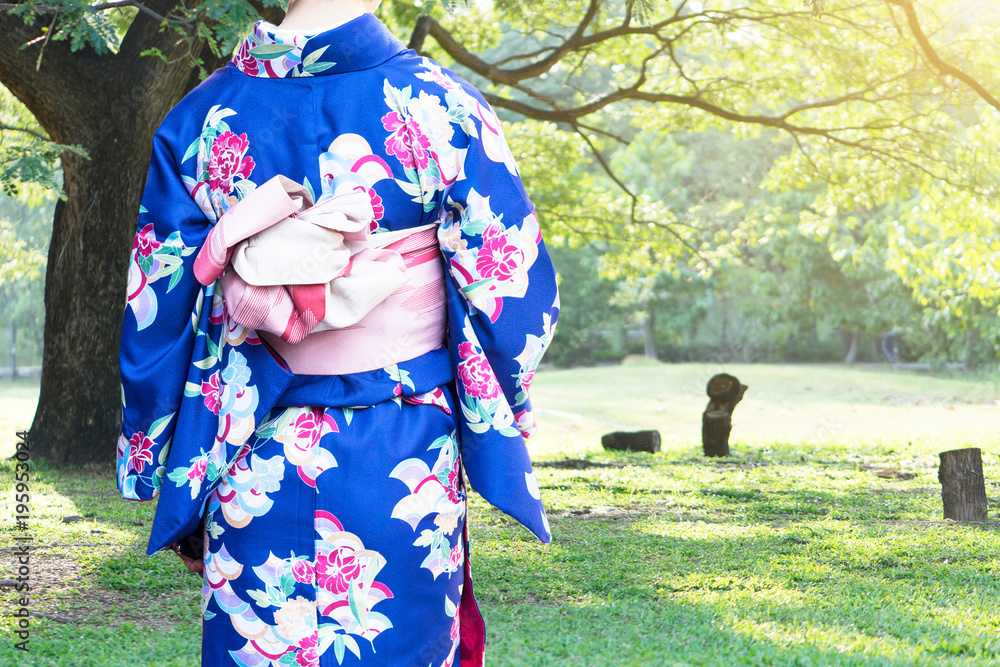 Woman wearing Kimono traditional Japan walking at public park.