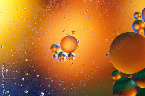 Fototapeta Naklejka Na Ścianę i Meble -  Oil bubbles in an aqueous medium on the border with a glass surface. Abstract Screen Saver.