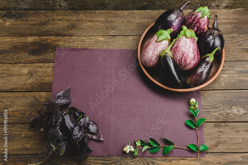 Fresh eggplant on a wooden background