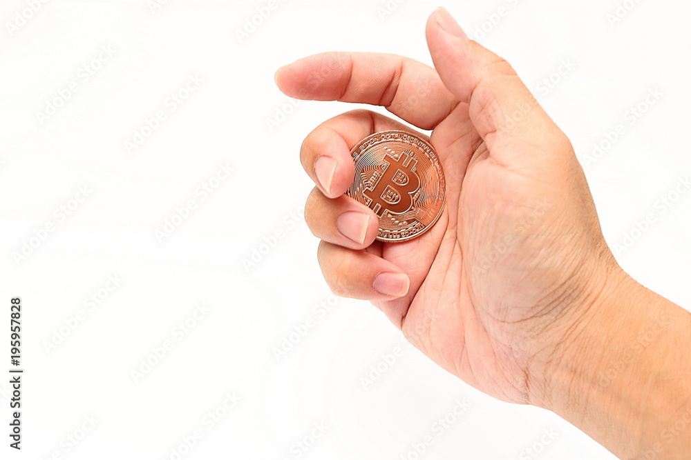 Human's hand holding cryptocurrency bronze bitcoin on white isolated background. Virtual digital money concept. Human's hand holding cryptocurrency bronze bitcoin on white isolated background. Virtual digital money concept.