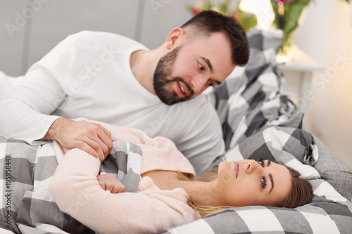 Adult attractive couple in bed having problem