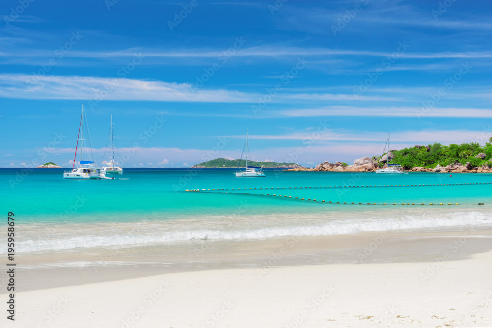 Sailboat at Anse Lazio beach at Praslin island, Seychelles.  Summer vacation and travel concept.  