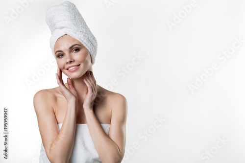 I like spa. Waist up portrait of cheerful young woman relaxing after bathing procedure. She is touching her soft skin with pleasure and smiling. Isolated and copy space