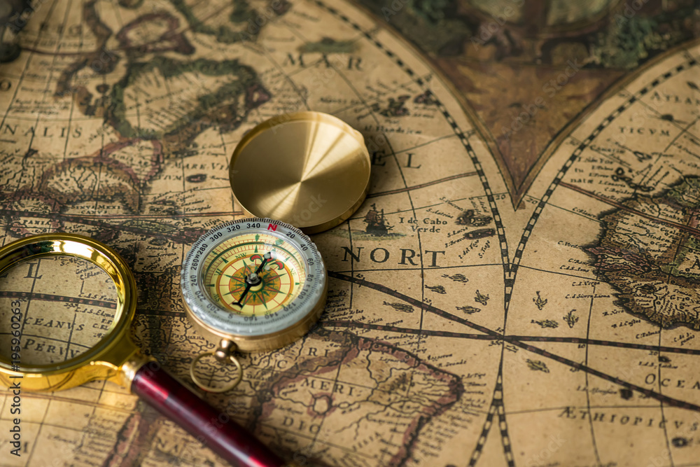 Retro compass with old map and magnifier Retro compass with old map and magnifier