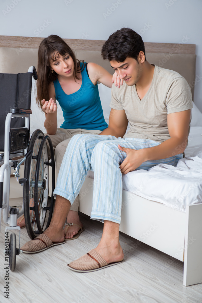 Desperate man on wheelchair with his sad wife Desperate man on wheelchair with his sad wife
