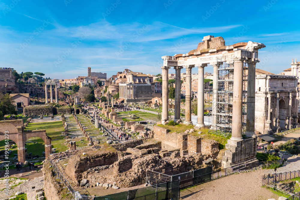 The ruins of the Roman Forum in Rome, Italy with the Colosseum visible in the back