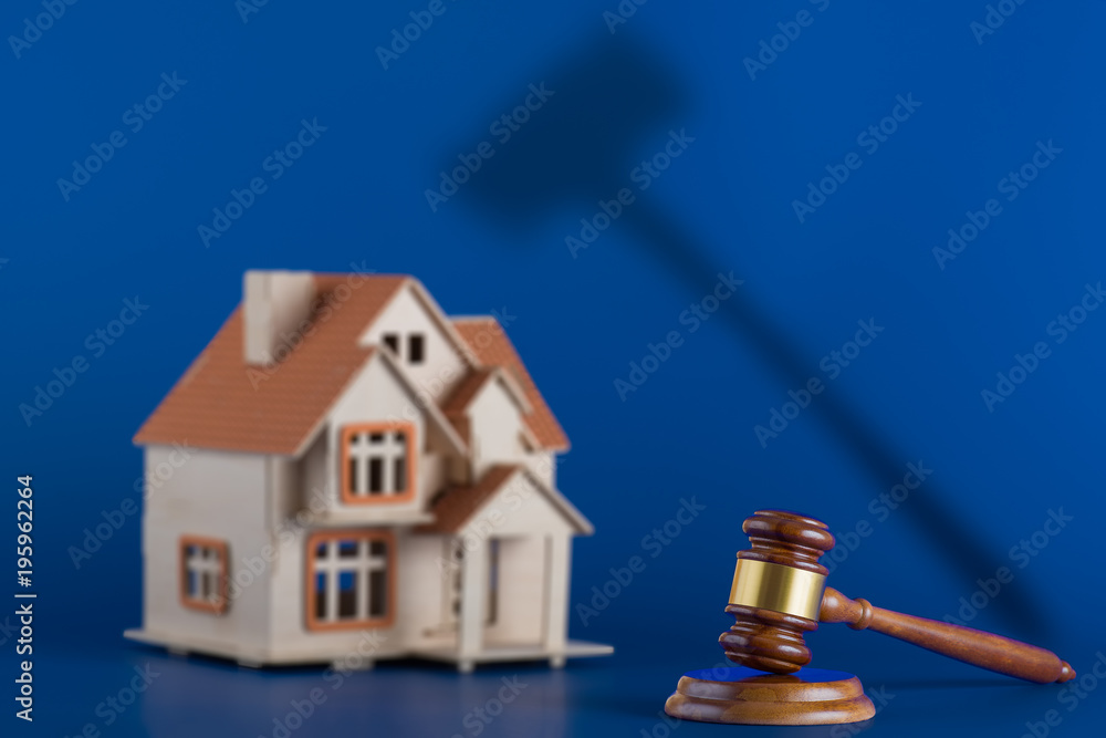 custom made wallpaper toronto digitalGavel and model house on blue background. The gavel casts an ominous shadow over the house. Concept for house auction or real estate law
