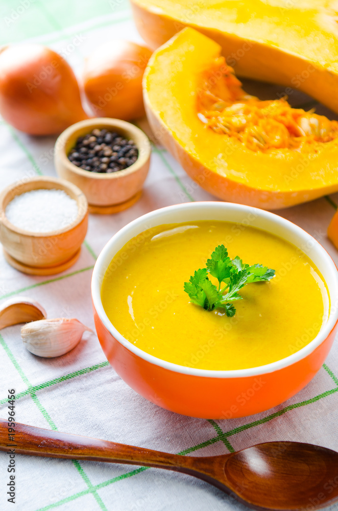 Pumpkin soup served on the table in bowl Pumpkin soup served on the table in bowl