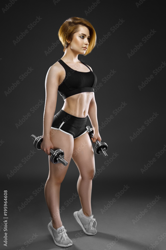 Attractive strong woman exercise with dumbbells Attractive strong woman exercise with dumbbells