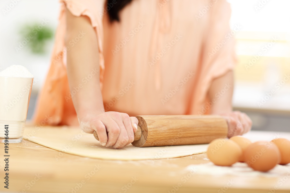 Young woman trying to cook something in kitchen Young woman trying to cook something in kitchen
