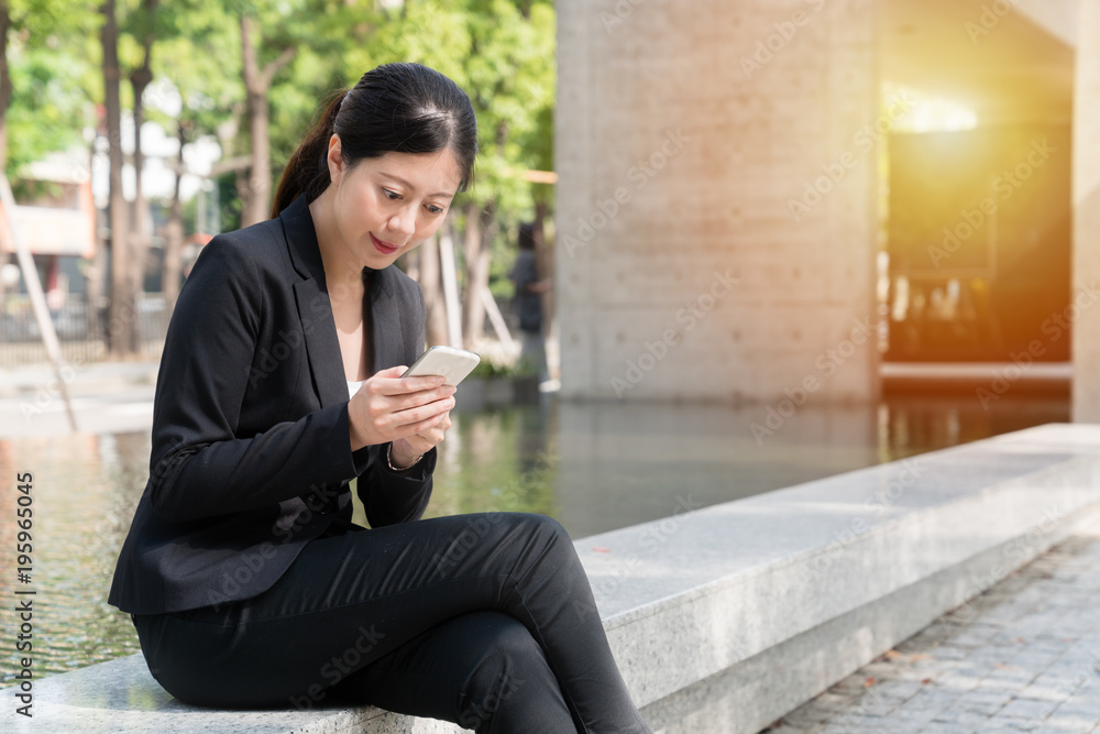 professional young Asian texting message professional young Asian texting message