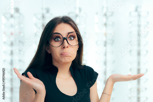 Canvas Print Undecided Woman Surrounded by Glasses in Eyeglasses Store