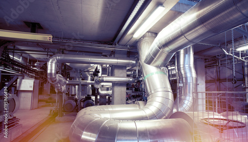 Equipment, cables and piping as found inside of a modern industrial power plant