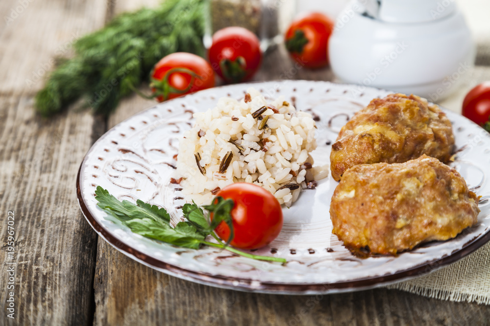 Delicious cutlets, rice, tomatoes and parsley