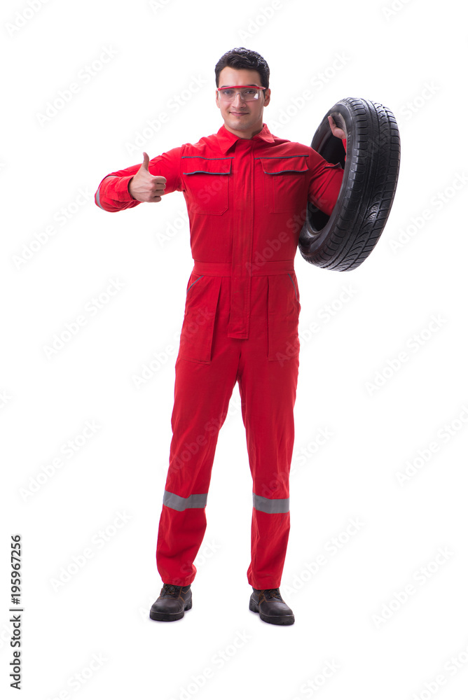 Young tyre repairman in red coveralls isolated on white backgrou Young tyre repairman in red coveralls isolated on white backgrou