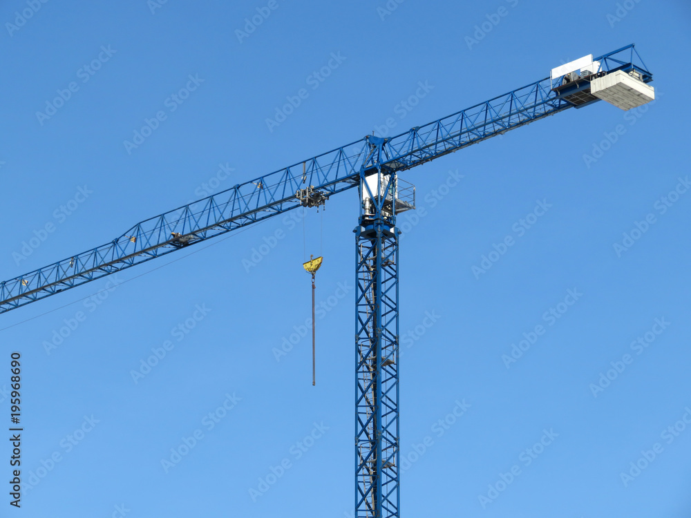 Building crane on the background of clear blue sky Building crane on the background of clear blue sky