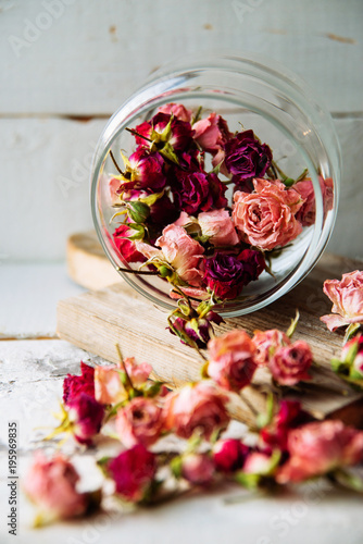 dried rose buds on turquoise wooden surface