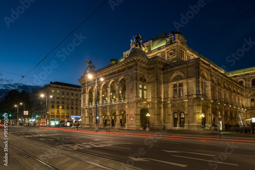 Wide shot of traffic passing the Vienna Opera House