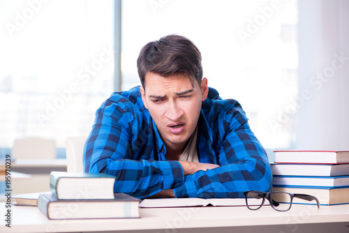 Student studying in the empty library with book preparing for ex photo