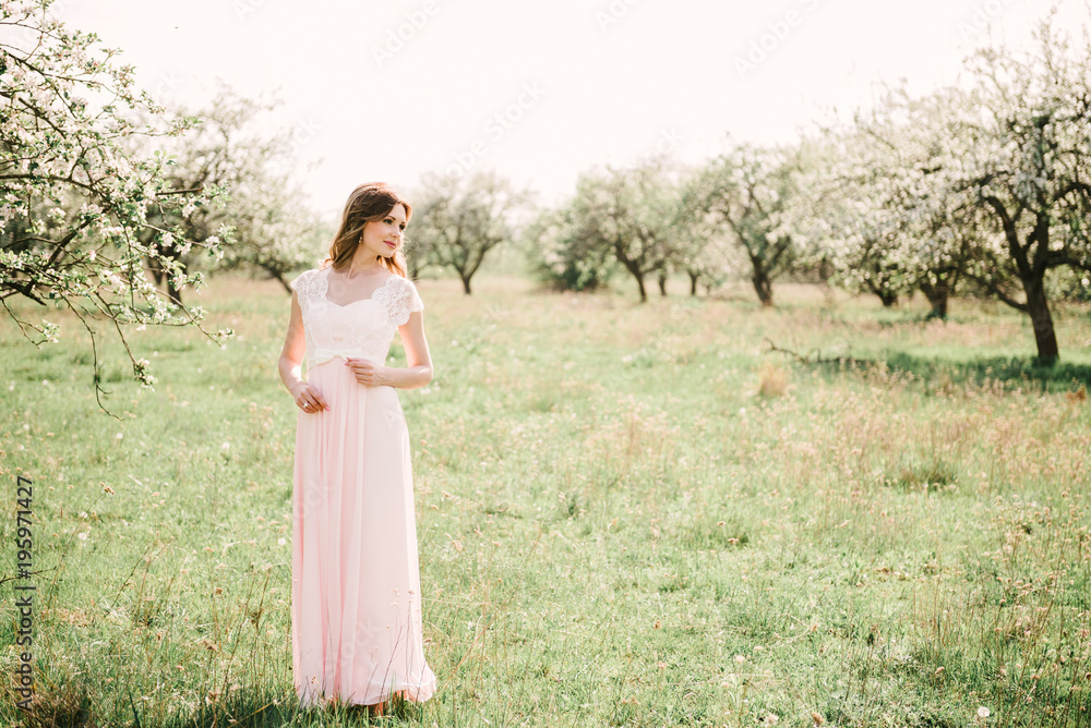 Portrait of a beautiful girl in the garden of blossoming apple trees Portrait of a beautiful girl in the garden of blossoming apple trees