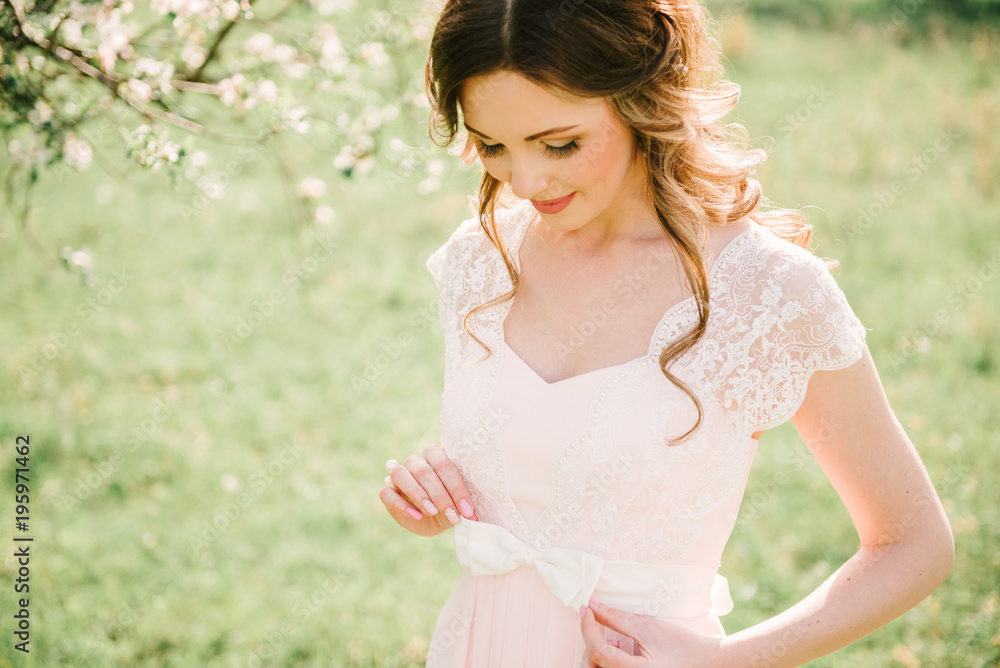 Portrait of a beautiful girl in the garden of blossoming apple trees Portrait of a beautiful girl in the garden of blossoming apple trees