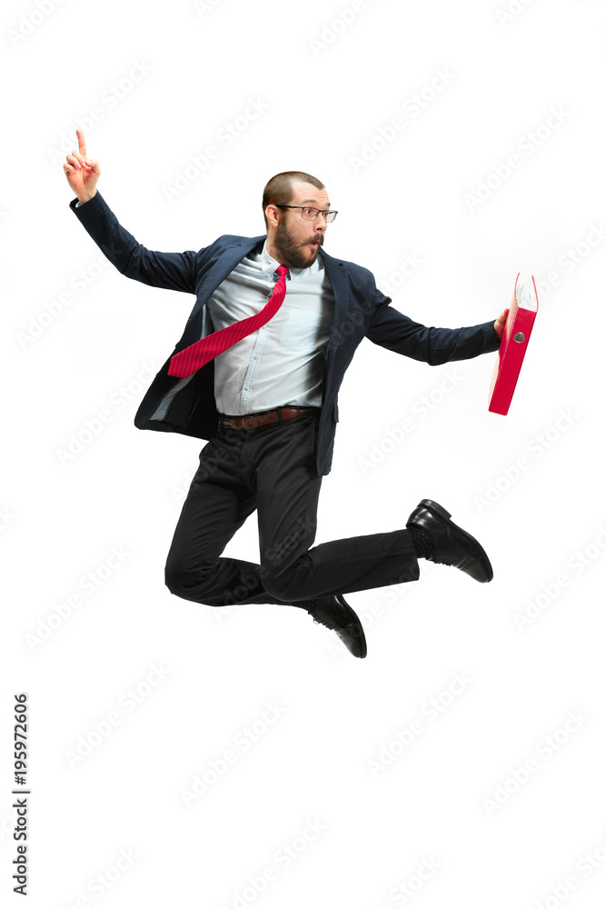 Funny cheerful businessman jumping in air over white background
