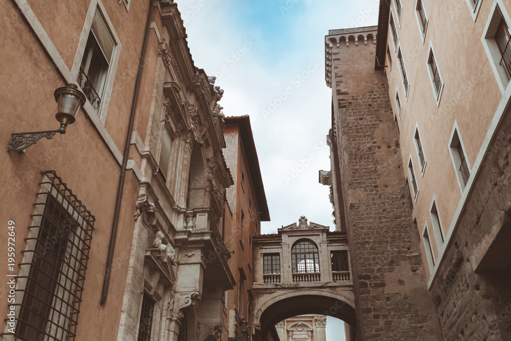 Narrow street with arch in historical quarter of Rome