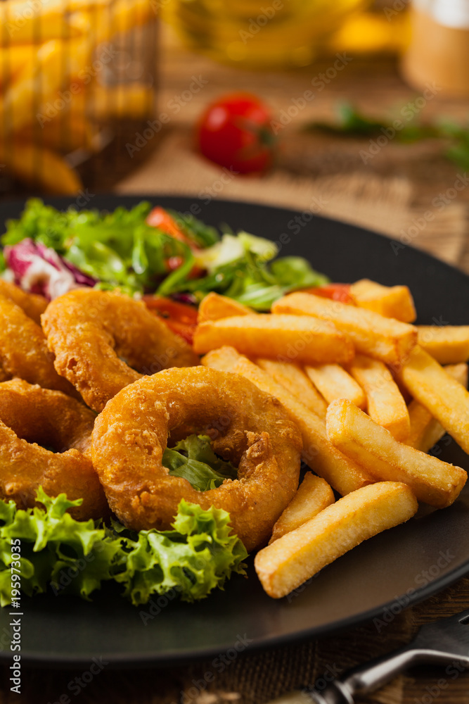 Roasted squid rings with fries. Roasted squid rings with fries.