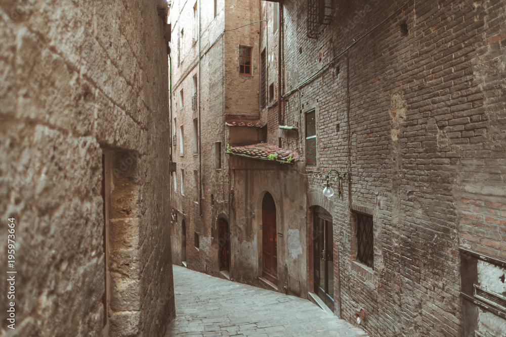 Steep street in historical quarter of Siena