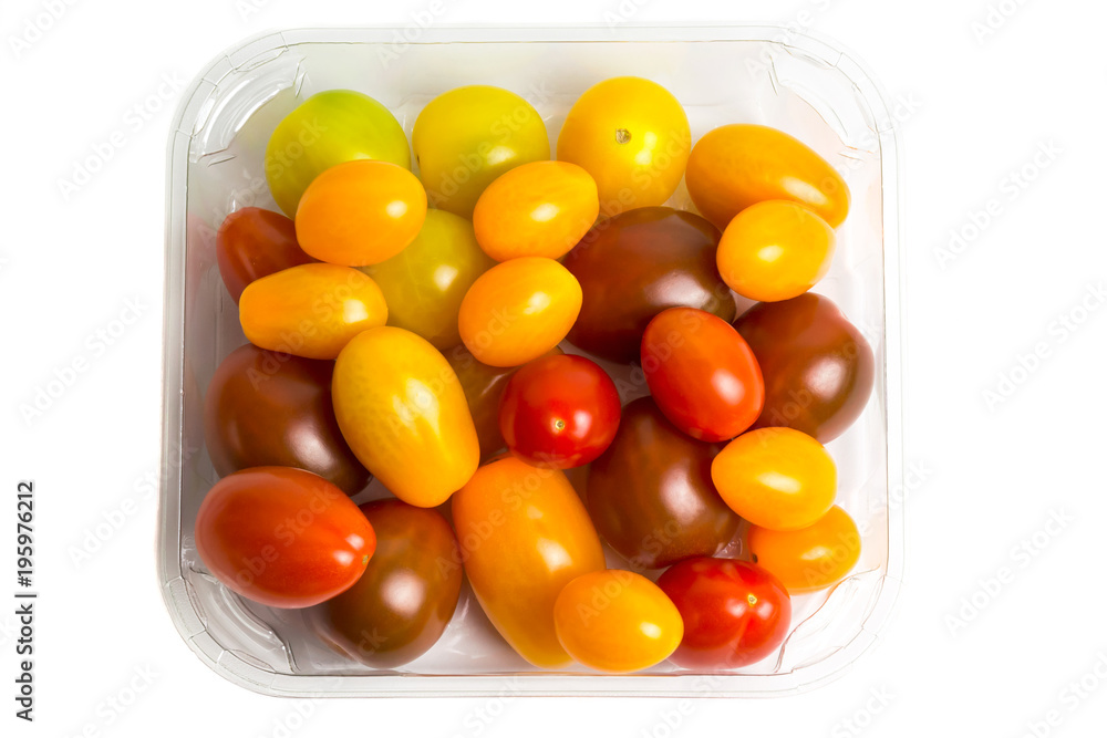 Cherry colored tomatoes in a plastic container on white background, isolated. Top view Cherry colored tomatoes in a plastic container on white background, isolated. Top view