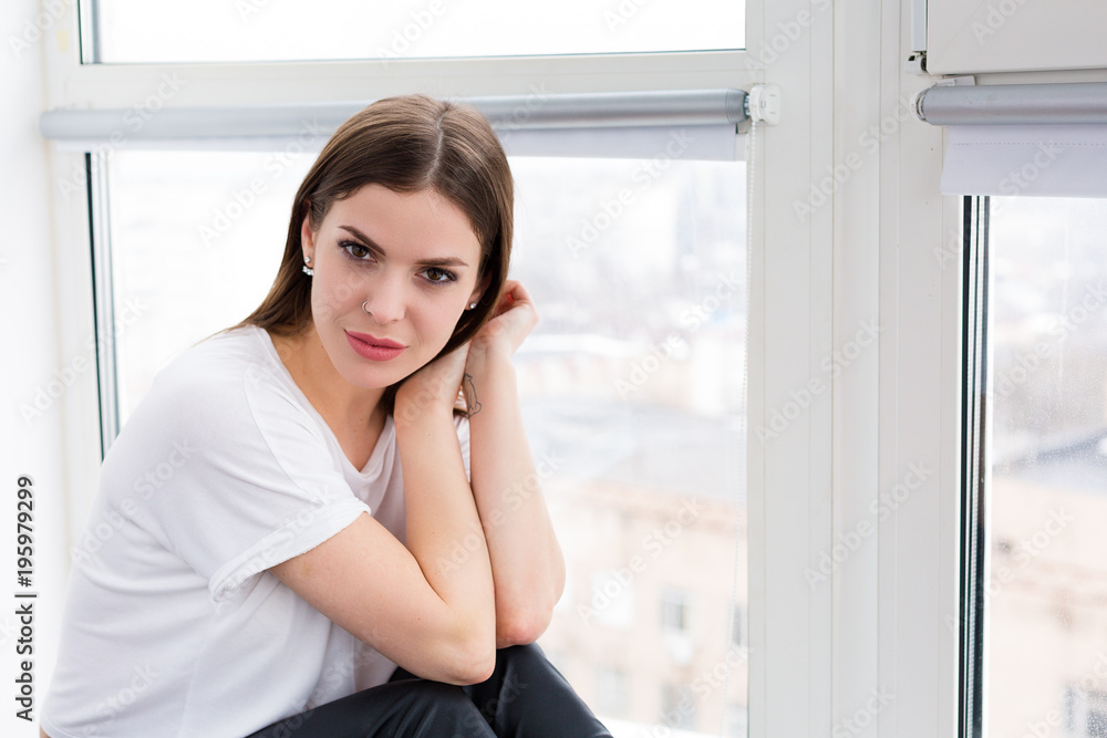 Beautiful woman sitting by the window Beautiful woman sitting by the window