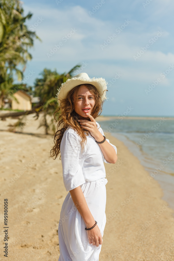 attractive girl walking on tropical sandy beach at the sea attractive girl walking on tropical sandy beach at the sea