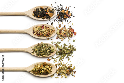 variety of tea blend on wooden spoon on white background