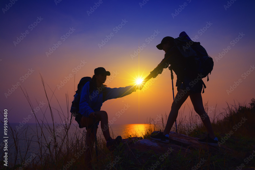 Fototapeta premium Young asian couple climbing up on the mountain,hiking and team work concept.