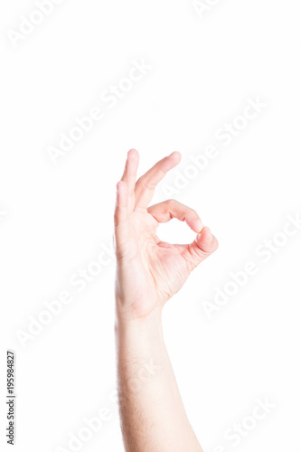 Hand esturing OK sign, on white background. photo