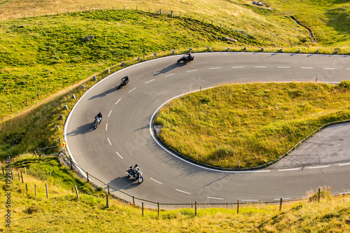 Motorcycle drivers riding in Alpine highway on famous Hochalpenstrasse, Austria, Europe. photo