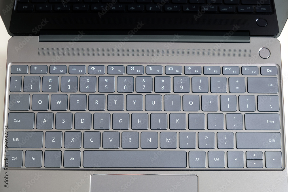 Opened modern laptop keyboard with USA alphabet on keys front top view close up