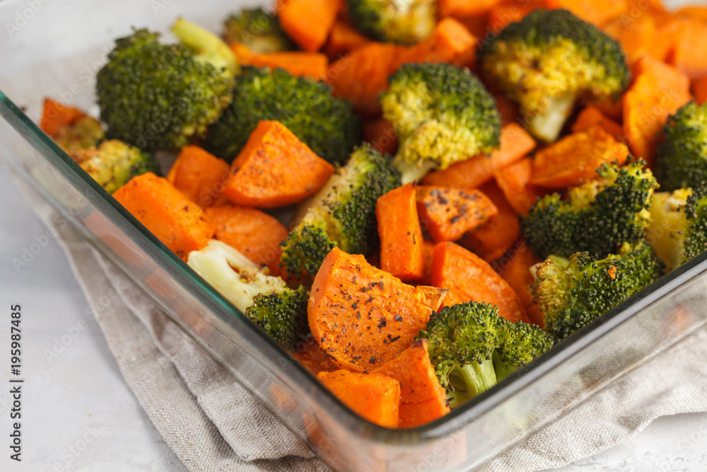 Baked broccoli and sweet potato with spices in a glass dish. Vegan Healthy Food Concept. Baked broccoli and sweet potato with spices in a glass dish. Vegan Healthy Food Concept.