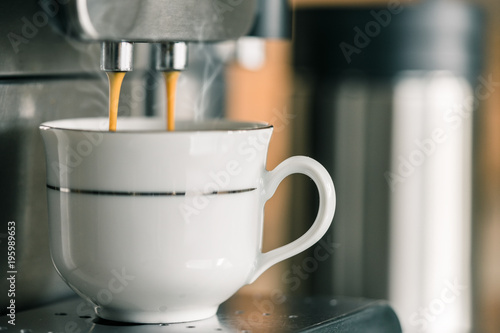 Coffee machine making strong espresso, closeup, copy space