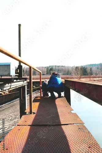 father and daughter look at hydrodynamic power in vintage look