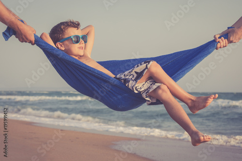 Happy little boy relaxing on the beach at the day time #195991452